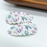 Fun scalloped snap clips in pretty prints and sparkly glitters!