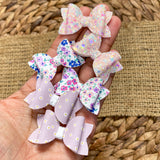 Adorable floral or glitter tiny pigtail bows!