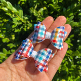 Rich coloured solid or printed faux leather 2" stacked pigtail bows!