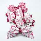 Adorable pink conversation candy heart bows, perfect for Valentine's Day!