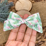 Gorgeous wintery pine and holly bows, perfect for the holidays!