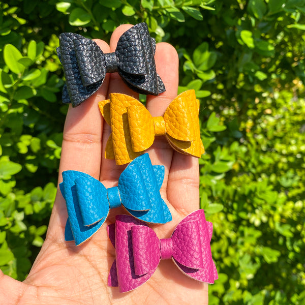 Gorgeous faux leather 2" stacked pigtail bows in beautiful rich colours!