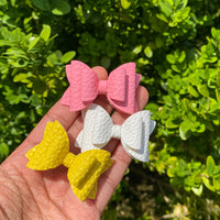 Beautiful faux leather 2" stacked pigtail bows in pretty colours!