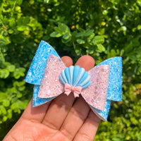 Sweet pastel pink and blue glitter bows with seashell applique!