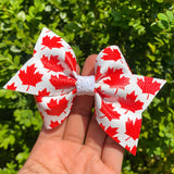 Red and white maple leaf bows, perfect for Canada Day