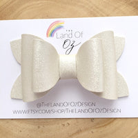 Gorgeous pink or white shimmer faux leather bows.