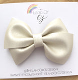 Gorgeous pink or white shimmer faux leather bows.