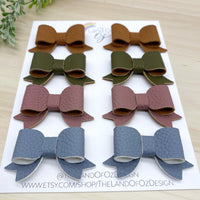 Adorable faux leather or suede pigtail bows in perfect neutral shades!