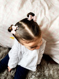 Adorable faux leather or suede pigtail bows in perfect neutral shades!