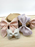 Gorgeous glitter lace bows in pretty pastel shades.