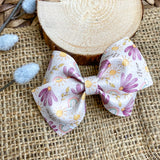 Beautiful muted purple floral and rainbow bows!