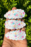 Adorable scalloped snap clips in cute prints or sparkly glitter!