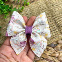 Beautiful muted purple floral and rainbow bows!