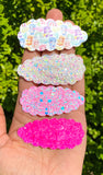Adorable scalloped snap clips in cute prints or sparkly glitters!