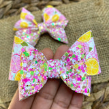 Sweet and summery pink and yellow grapefruit print and sparkly glitter bows
