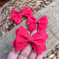 Simple and elegant, red metallic splatter faux suede bows, perfect for the holidays!