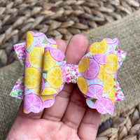 Sweet and summery pink and yellow grapefruit print and sparkly glitter bows