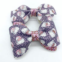 Adorable pink and purple leopard print Santa bows, perfect for Christmas!