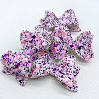 Adorably tiny glitter pigtail bows perfect for Valentine's Day!