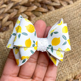 Beautiful bright and summery lemon print faux leather bows!