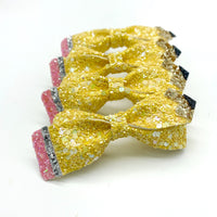 Adorable faux leather or chunky glitter pencil bows!