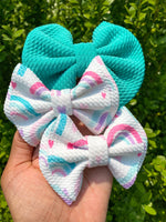 Adorable hearts and rainbows bullet fabric bow clips or headbands.