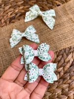Adorable dainty green and white floral pigtail bows!