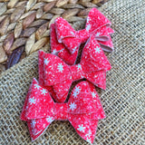 Sparkly red or green  snowflake glitter bows, perfect for the holidays!