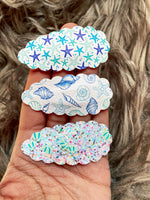 Fun scalloped snap clips in pretty prints and sparkly glitters!