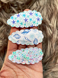 Fun scalloped snap clips in pretty prints and sparkly glitters!