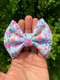 Adorable pink and purple floral bullet fabric bow clips or headbands.