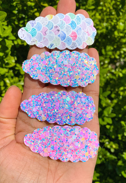 Adorable scalloped snap clips in pretty marbled mermaid scales or sparkly bubble glitters!