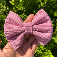 Pink cable knit bullet fabric bow clips or headbands.