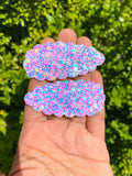 Adorable scalloped snap clips in pretty marbled mermaid scales or sparkly bubble glitters!