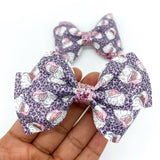 Adorable pink and purple leopard print Santa bows, perfect for Christmas!